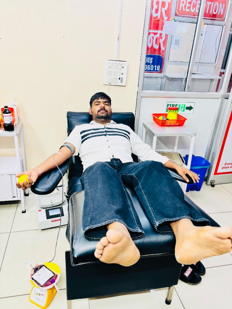 Donor giving blood at reception area
